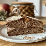 Close-up of sliced Dinkel-Kürbisbrot showcasing the moist texture and pumpkin seeds.