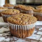 Close-up view of healthy wheat bran muffins, showcasing a golden brown exterior and a soft texture.