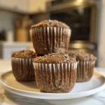 Close-up view of moist High Fiber Protein Muffins with a golden-brown crust.