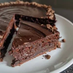 Close-up view of a Maronen-Schoko-Kuchen with a glossy chocolate glaze.