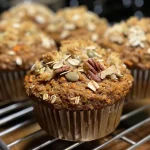 Close-up view of nutty whole wheat air fryer muffins with visible textures and ingredients.