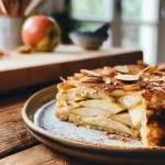 ['A close-up side view of a slice of Protein Apfelkuchen, showcasing its moist texture and apple chunks.', 'A detailed side angle of a protein apple cake, highlighting juicy apples and a golden crust.', 'A vibrant slice of Protein Apfelkuchen, displaying its rich, tender interior filled with apple pieces.', 'A side view of a delicious slice of apple protein cake, emphasizing its appealing layers and topping.']