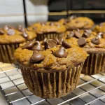Close-up of gluten-free protein pumpkin muffins showcasing their texture and chocolate chips.