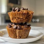 Close-up view of freshly baked golden gluten-free protein pumpkin muffins with chocolate chips.